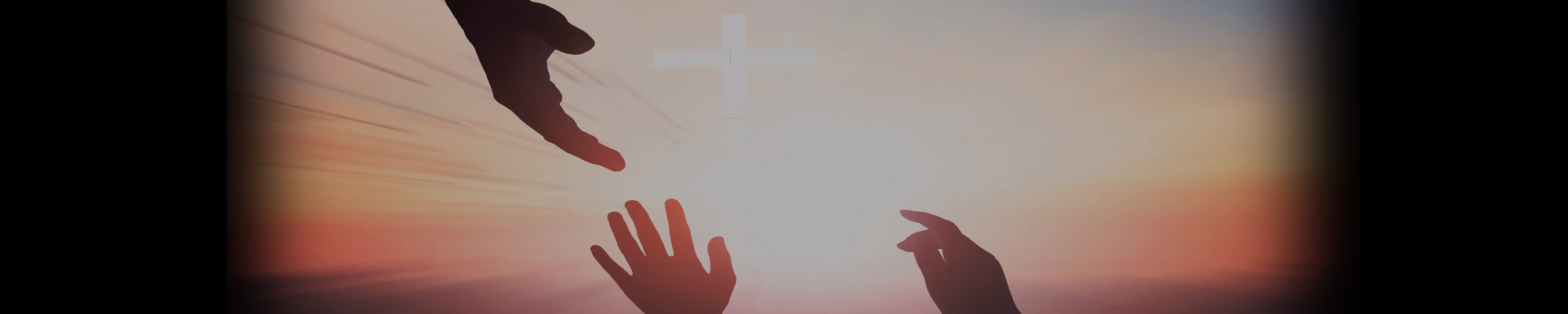 Silhoutte of a hand reaching down toward the raised hands of another individual